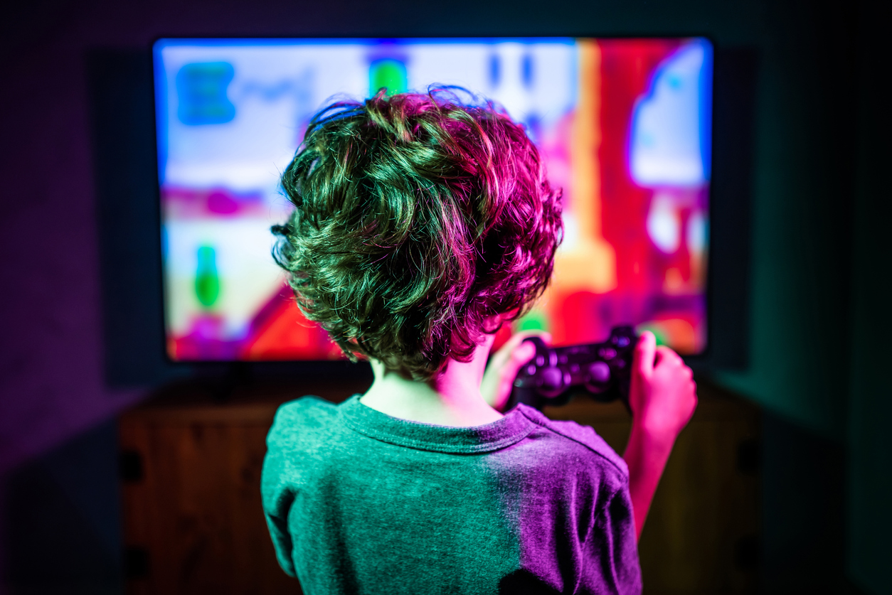 Danger games. Little boy playing video game